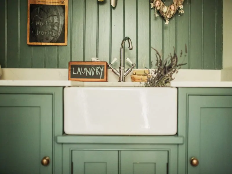 Belfast sink in laundry room with a chalk board with the word laundry written on it