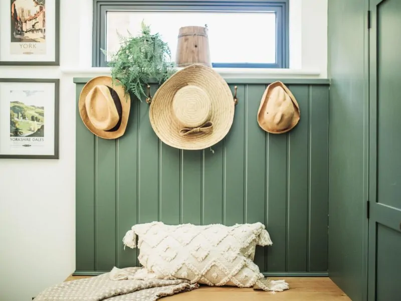 Boot Room, with three hats hanging on the wall