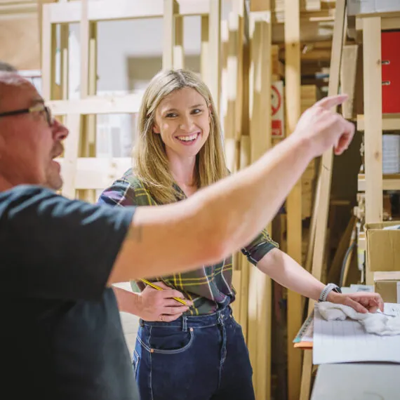 Examining a kitchen cabinet with a client.