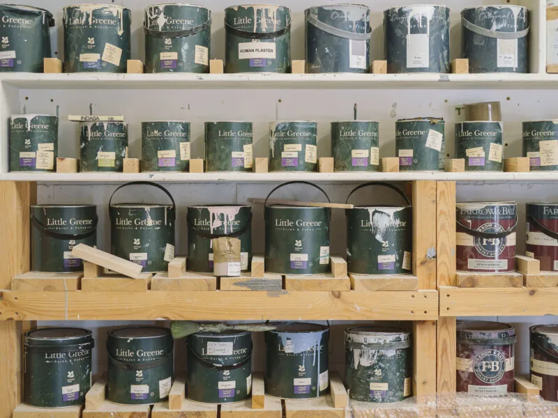 Rows of paint cans on shelves