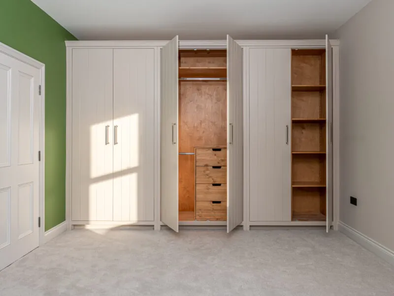 Wardrobes across a wall with the doors open