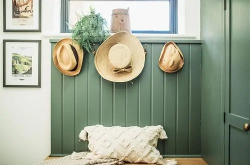 Boot Room, with three hats hanging on the wall